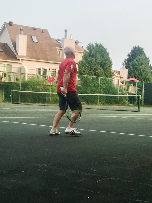 Brad Macdonald on the community tennis courts at dusk